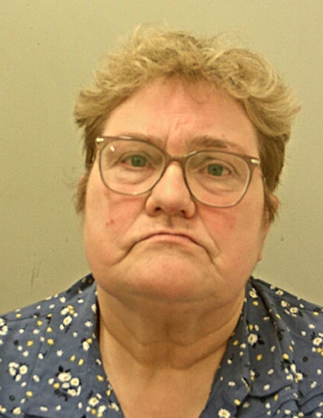 Police mugshot of Karen Foster wearing glasses and a blue top 