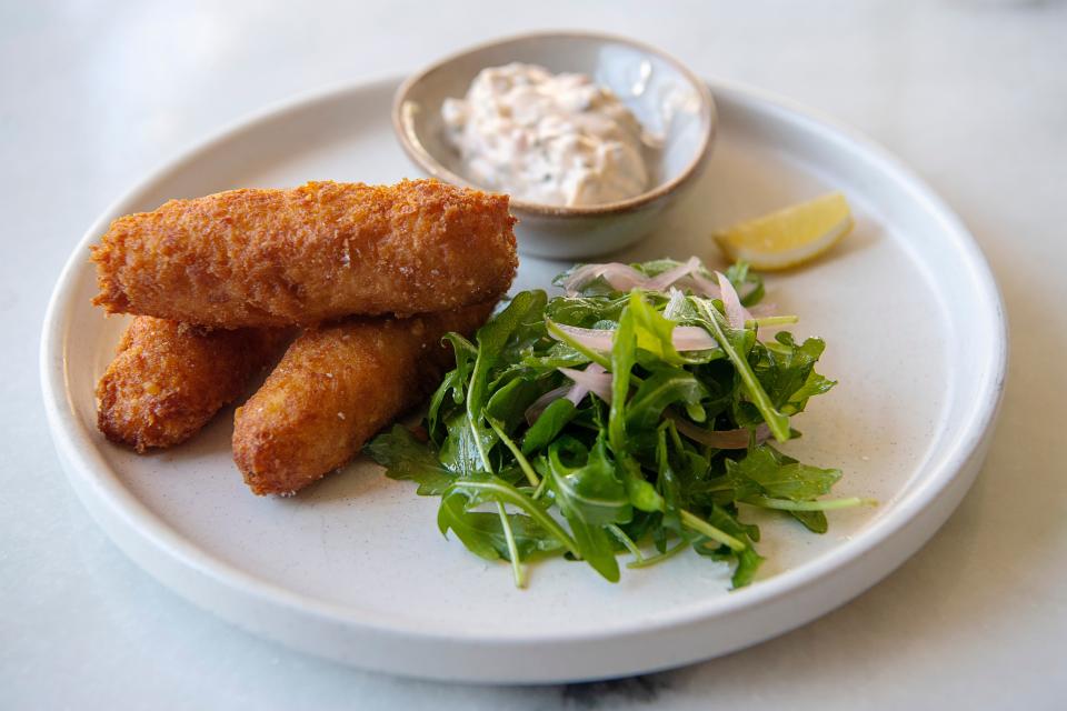 La Bodega’s Croquetas de Bacalao are salt cod potato fritters with tartar sauce and an herb salad.