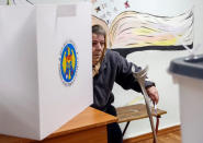 A woman leaves a booth before casting her vote during a presidential election at a polling station in Chisinau, Moldova, October 30, 2016. REUTERS/Gleb Garanich
