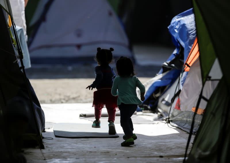 Migrant girls, asylum seekers sent back to Mexico from the U.S. under the Remain in Mexico program officially named Migrant Protection Protocols (MPP), are seen playing at a provisional campsite near the Rio Bravo in Matamoros