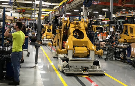 Employees work at Caterpillar's small wheel loader assembly plant in Clayton, North Carolina, U.S., August 29, 2018. Picture taken August 29, 2018. REUTERS/Rajesh Singh