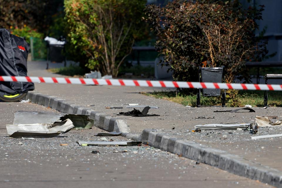 Police officers use tape to block off the area near a damaged multi-storey residential building following an alleged Ukrainian drone attack (REUTERS)