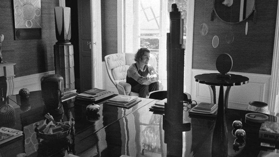 Lagerfeld is pictured in his apartment on Rue de l’Université in the early 1960s, surrounded by an eclectic selection of furnishings and artwork. - Georges Kelaïditès/Roger-Viollet/TopFoto/Courtesy Thames & Hudson