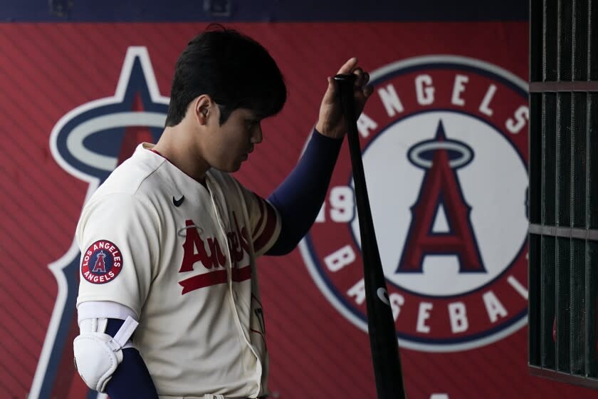 Los Angeles Angels' Shohei Ohtani grabs his bat during the first inning of a baseball game,