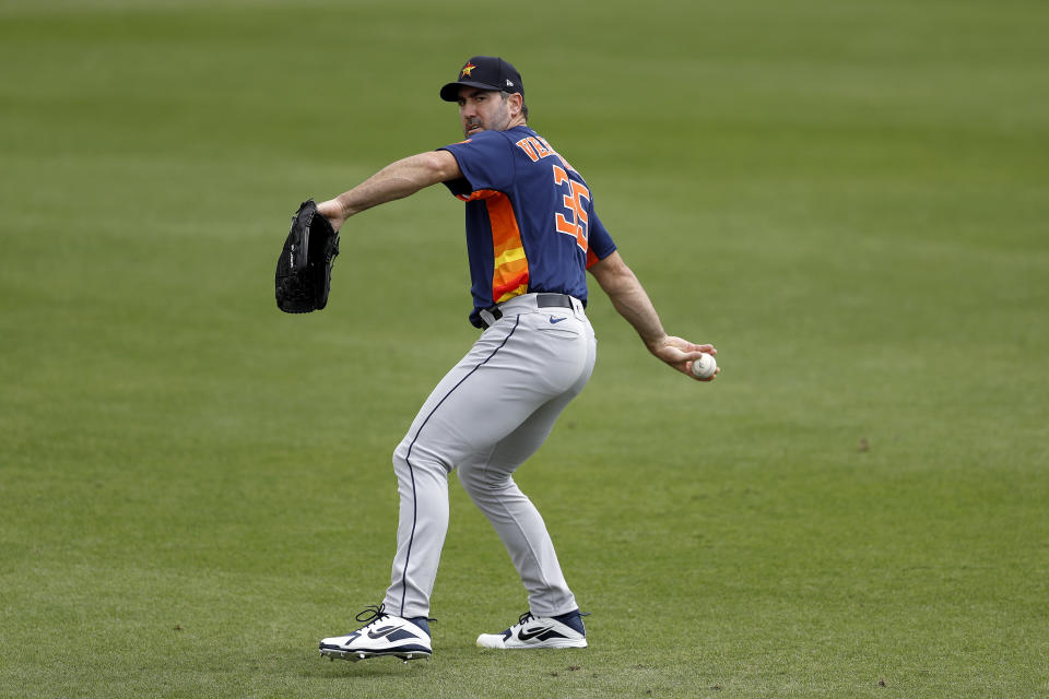 Houston Astros pitcher Justin Verlander warms up prior to a spring training baseball game against the St. Louis Cardinals, Tuesday, March 3, 2020, in Jupiter, Fla. (AP Photo/Julio Cortez)