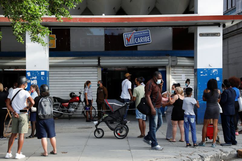 FILE PHOTO: People line up to enter a store in downtown Havana