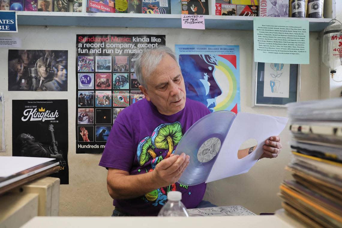 Yesterday and Today Records owner Evan Chern looks at a translucent vinyl record while working at his record store on west Bird Road at 9274 SW 40th St. in Miami, Florida, Feb. 2, 2024. Colored vinyl and other LP exclusives are a big selling point on Record Store Day, which in 2024 will be held on Saturday, April 20.