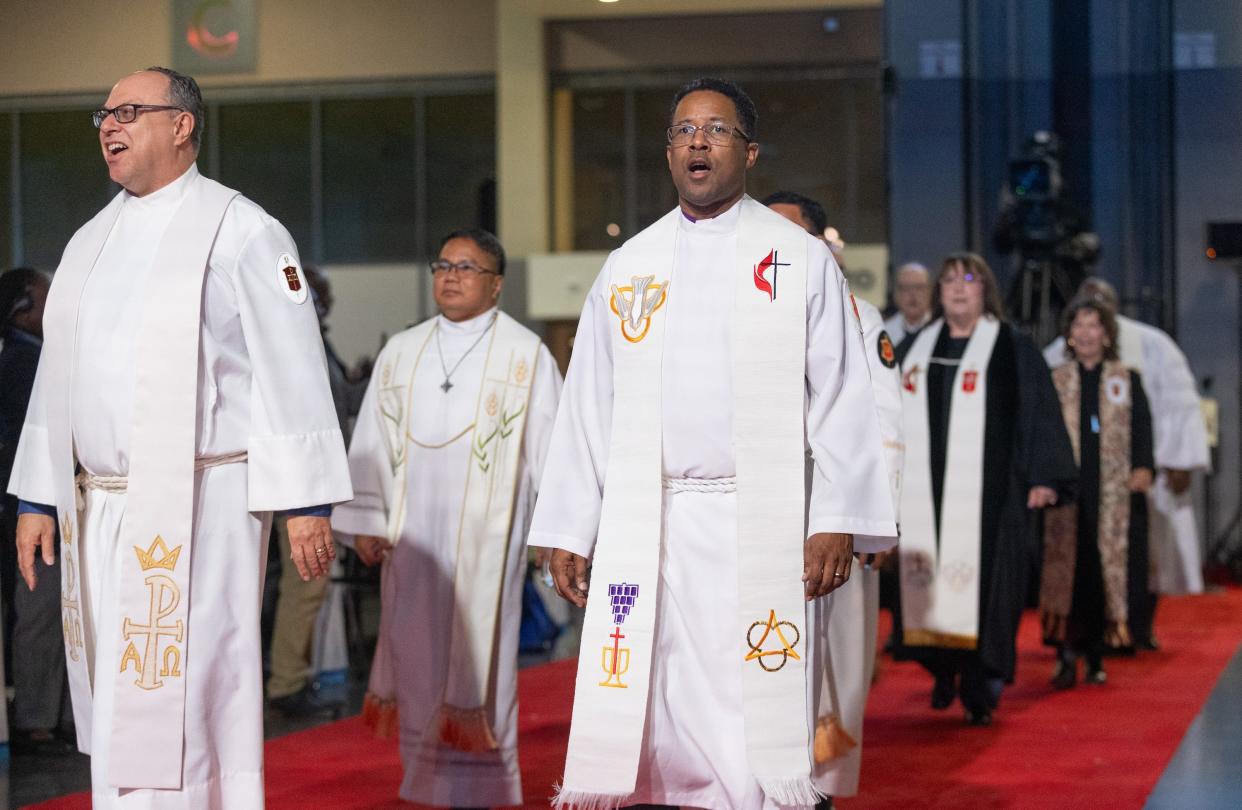 A procession of United Methodist bishops leads opening worship at the 2024 United Methodist Church General Conference in Charlotte, N.C. The general conference hasn't gathered for a regular session in eight years, setting up the denomination's top legislative meeting to be historic.