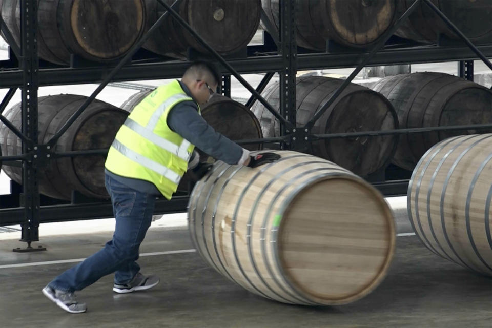 In this image from a video, a worker pushes a whisky cask at the Chuan Malt Distillery in Emeishan in southwestern China's Sichuan province on Dec. 13, 2023. The more than $100 million distillery owned by Pernod Ricard and based at the UNESCO World Heritage site Mount Emei, launched a pure-malt whisky, The Chuan, aiming to tap a growing taste among young Chinese for whisky in place of the traditional "baijiu" used to toast festive occasions. (AP Photo/Caroline Chen)