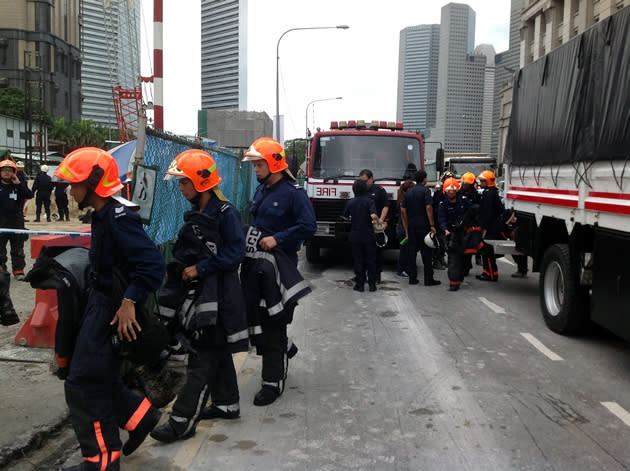 SCDF firefighters disembarking from a lorry to aid its search and extrication efforts. (Yahoo! photo/Jeanette Tan)