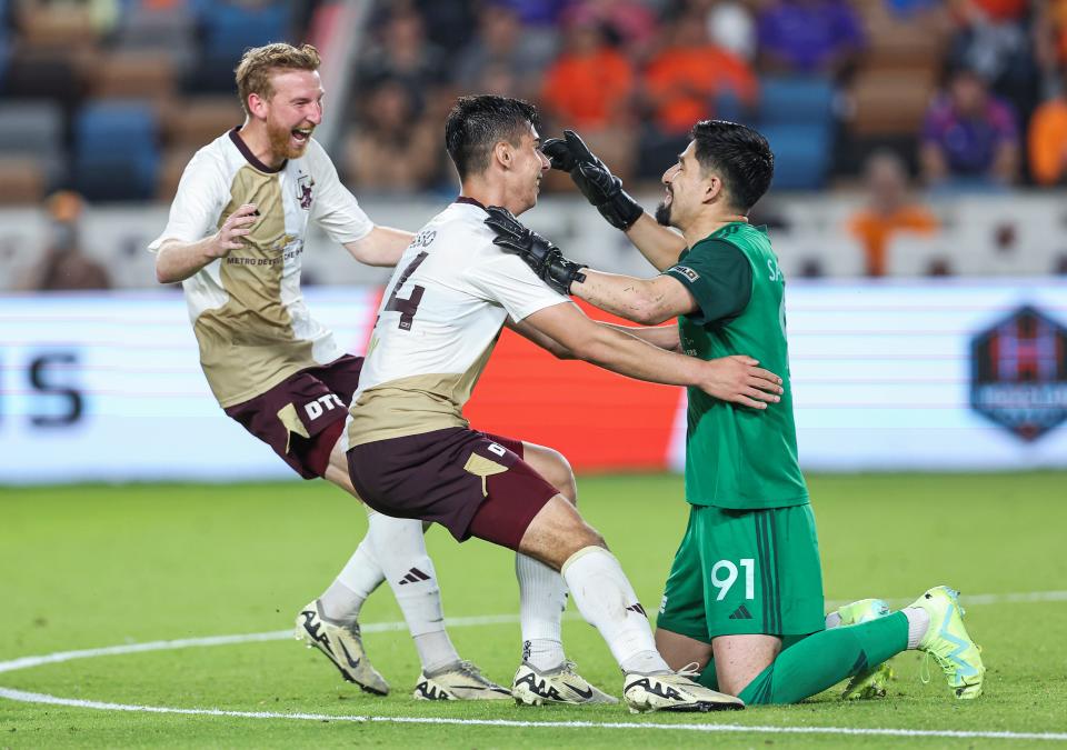 Detroit City FC goalkeeper Carlos Saldana (91) celebrates with teammates after the match against Houston Dynamo FC at Shell Energy Stadium in Houston on Tuesday, May 7, 2024.