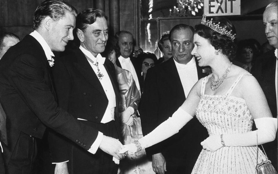 Peter O'Toole bows to Queen Elizabeth II after a Command Performance showing of Lawerence of Arabia, in which he played the title role. The film's director David Lean stands next to O'Toole. - Bettmann