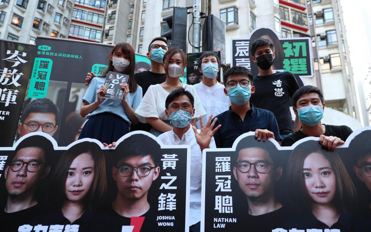 Joshua Wong, second from left front row, poses with other pro-democracy activists while campaigning for the primary - AFP