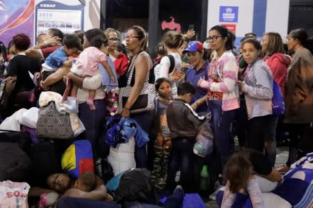 Venezuelan migrants wait at the Binational Border Service Center of Peru in Tumbes