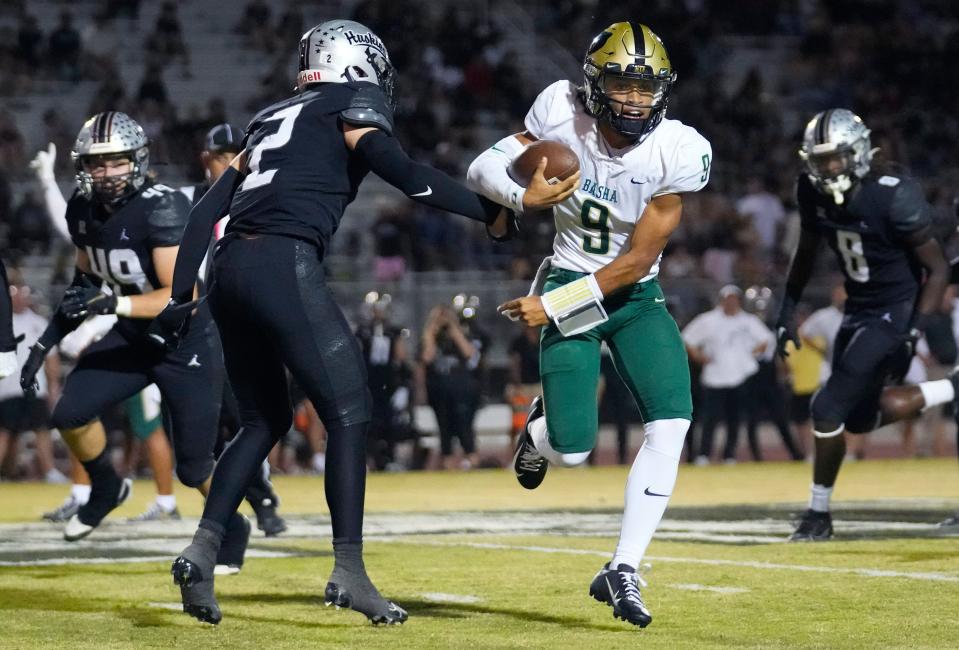 October 6, 2023; Chandler, Ariz.; USA; Basha quarterback Demond Williams Jr (9) breaks a tackle from Hamilton Jackson Finefrock (2) during a game at Hamilton High School.