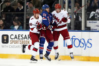 Carolina Hurricanes center Martin Necas, defenseman Brady Skjei and New York Rangers left wing Will Cuylle fight for the puck during the first period in Game 1 of an NHL hockey Stanley Cup second-round playoff series, Sunday, May 5, 2024, in New York. (AP Photo/Julia Nikhinson)