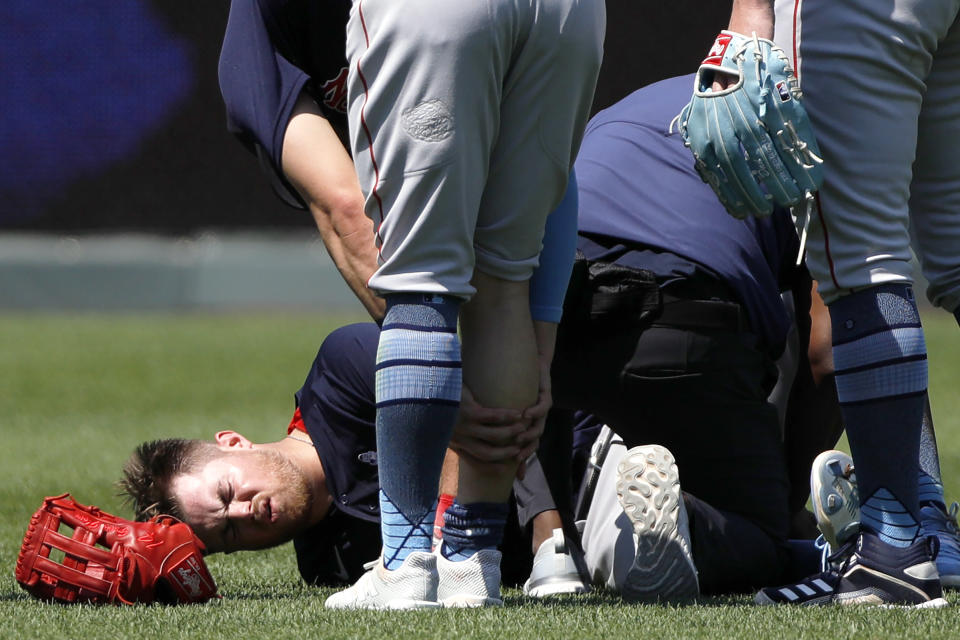 Boston Red Sox second baseman Christian Arroyo reacts after he was helped by the Red Sox training staff after colliding with center fielder Kiki Hernandez in the fifth inning of a baseball game against the Kansas City Royals at Kauffman Stadium in Kansas City, Mo., Sunday, June 20, 2021. Arroyo was taken out of the game. (AP Photo/Colin E. Braley)