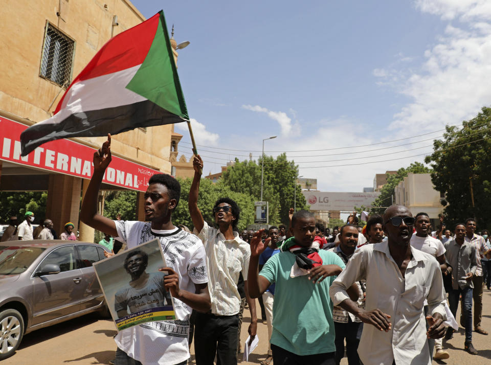 Sudanese protesters wave a national flag as they march to the Cabinet’s headquarters in the capital, Khartoum, Sudan, Monday, Aug. 17, 2020. The protesters returned to the streets Monday to pressure transitional authorities for more reforms, a year after a power-sharing deal between the pro-democracy movement and the generals. (AP Photo/Marwan Ali)
