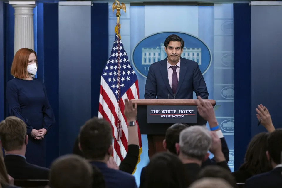 White House press secretary Jen Psaki looks on as deputy national security adviser Daleep Singh stands at a podium to take questions from reporters.