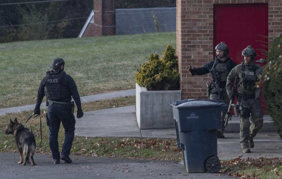 Police search a local church for a Marine deserter who is wanted for questioning in a murder case, in Roanoke, Va., Thursday, Nov. 14, 2019. (AP Photo/Don Petersen)