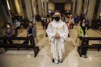 Parson Don Giuseppe Corbari poses prior to the start of a mass with faithfuls the SS. Quirico and Giulitta Church in Robbiano di Giussano, northern Italy, Monday, May 18, 2020. Masses with the presence of faithful resumed Monday, as Italy is easing its lockdown measures. (AP Photo/Luca Bruno)