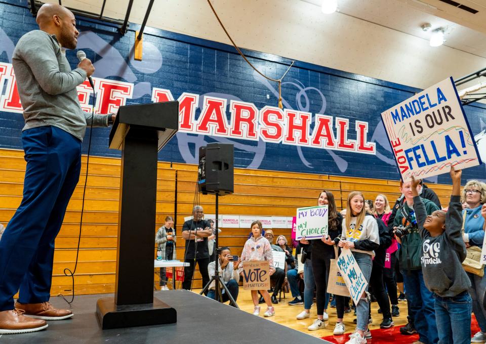 Lt. Governor Mandela Barnes, candidate for U.S. Senate, interacts with 7-year-old Chase Longmire, who was with her mother Chloe Longmire of Wauwatosa, at his rally, October 8, at John Marshall High School in Milwaukee.
