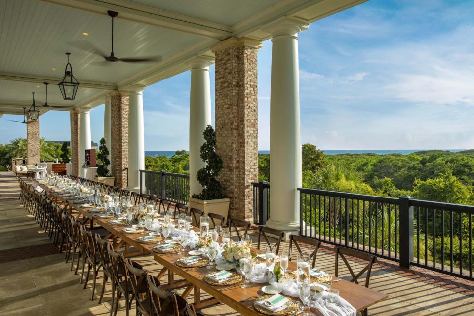 a large outdoor dining area with a large group of tables and chairs