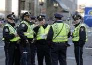 Boston Police officers receive instructions from their supervisor near the finish line before the 118th Boston Marathon Monday, April 21, 2014 in Boston. (AP Photo/Robert F. Bukaty)