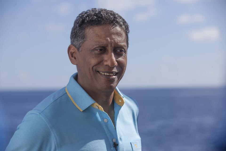 In this Saturday, April 13, 2019, photo, Seychelles President Danny Faure smiles during an interview with the Associated Press, on board the vessel Ocean Zephyr off the coast of Desroches, in the outer islands of Seychelles. President Faure was visiting a British-led science expedition exploring the depths of the Indian Ocean where scientists documented changes taking place beneath the waves that could affect billions of people in the surrounding region over the coming decades. (AP Photo/Steve Barker)