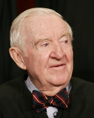 FILE PHOTO: Justice John Paul Stevens sits as Justices of the Supreme Court of the United States pose for a 2006..