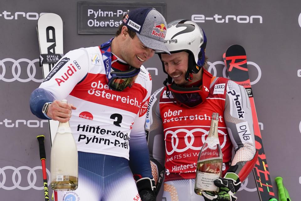 France's Alexis Pinturault, left, winner of an alpine ski, men's World Cup giant slalom, celebrates with third-placed Norway's Henrik Kristoffersen, in Hinterstoder, Austria, Monday, March 2, 2020. (AP Photo/Giovanni Auletta)