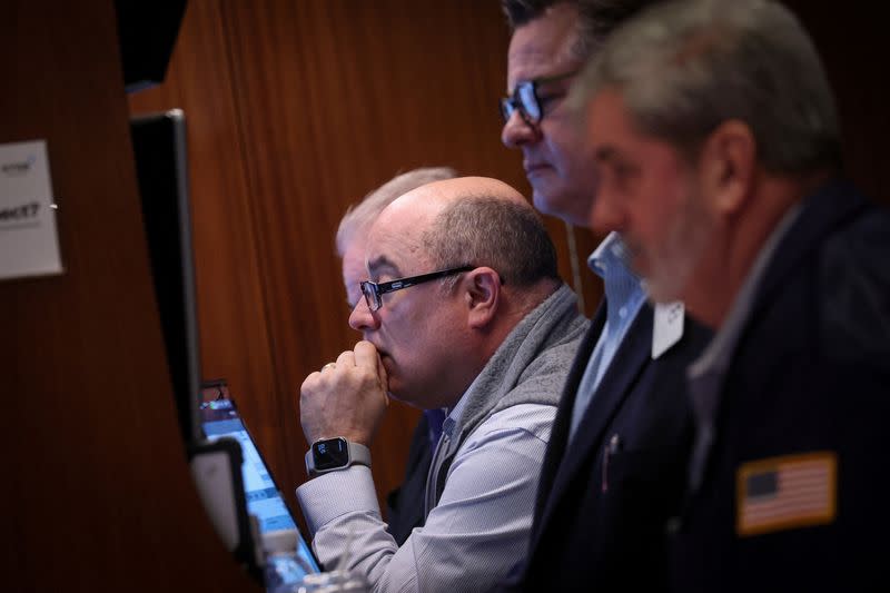 Traders work on the floor of the NYSE in New York