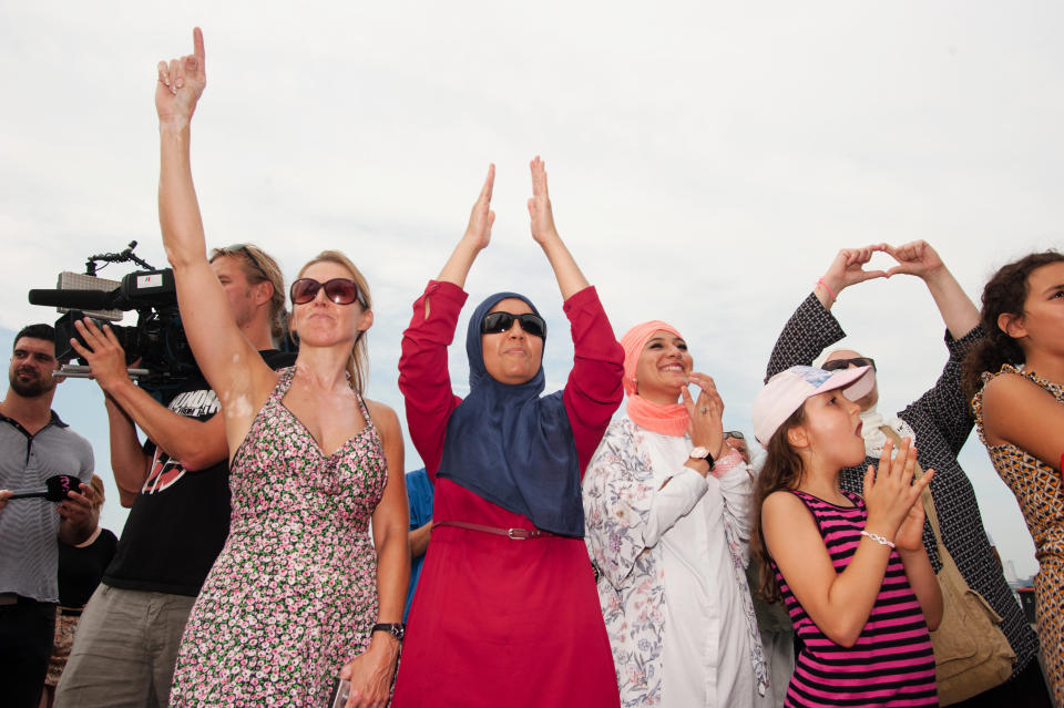 Women cheer in Antwerp at a&nbsp;beach party protest against the ban of burkinis in France.