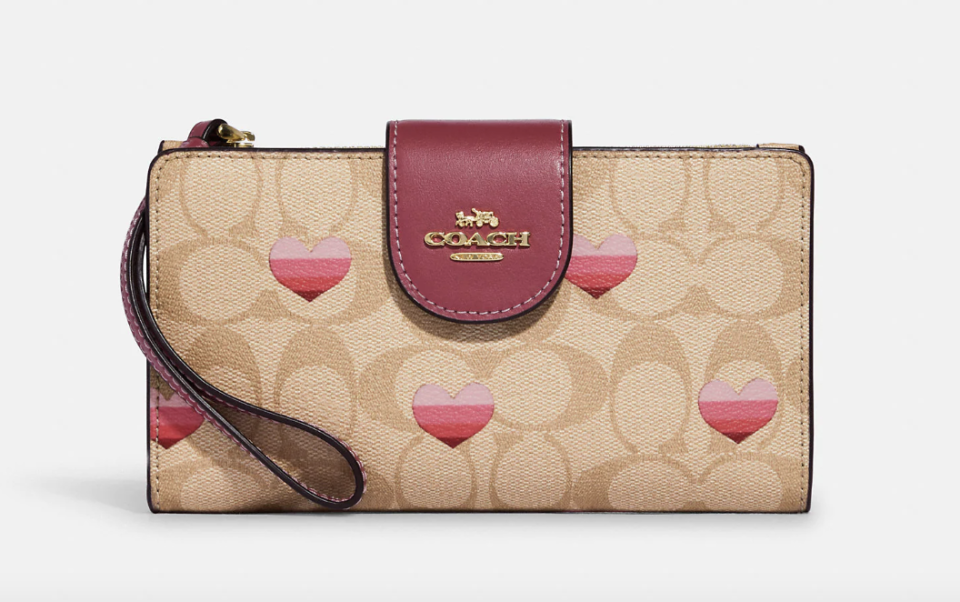 Tech Wallet In Signature Canvas With Stripe Heart Print (Photo via Coach Outlet)