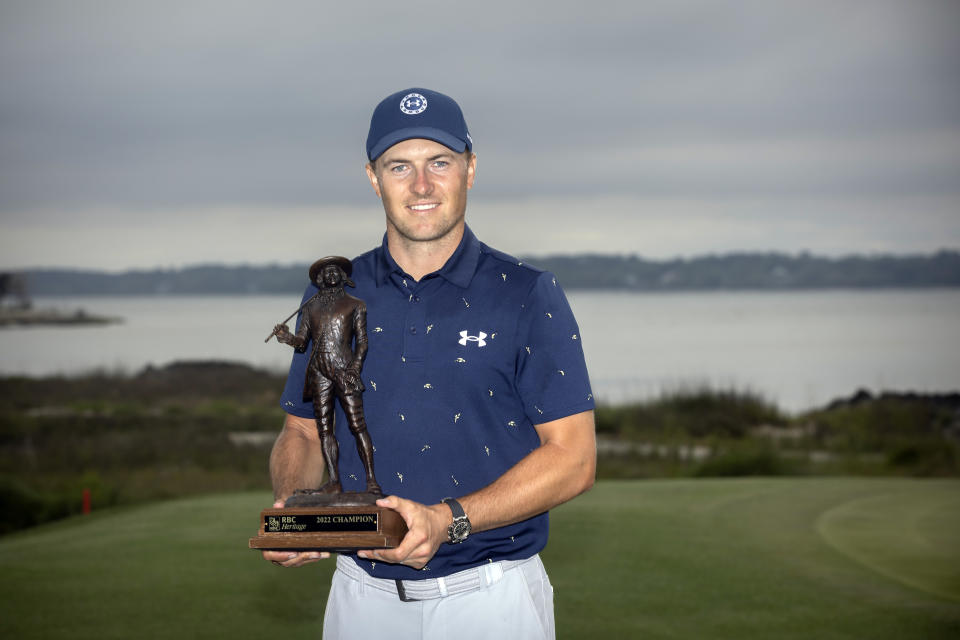 Jordan Spieth holds the championship trophy after winning a one-hole playoff at the RBC Heritage golf tournament, Sunday, April 17, 2022, in Hilton Head Island, S.C. (AP Photo/Stephen B. Morton)