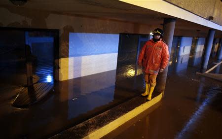 A rescue worker patrols a flooded street in Olbia, northeastern Sardinia island November 19, 2013. REUTERS/Tony Gentile