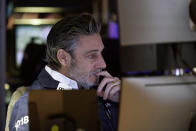 Trader John Romolo works on the floor of the New York Stock Exchange, Wednesday, Dec. 1, 2021. The latest move in Wall Street's jolting roller-coaster ride is back up, as stocks, oil and bond yields climb in early Wednesday trading to recover some of their sharp losses from the day before. (AP Photo/Richard Drew)