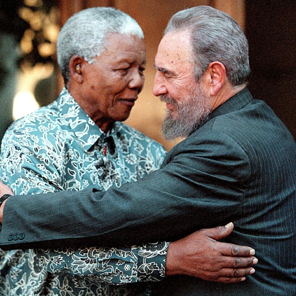Former South African President Nelson Mandela (L) hugs Cuban President Fidel Castro 