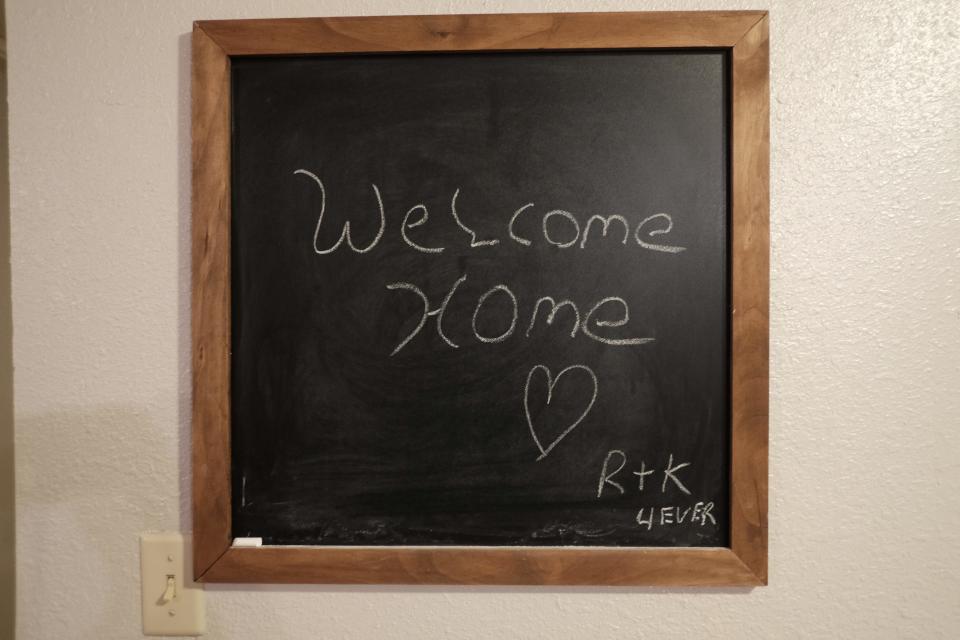 A blackboard with the words "Welcome Home" and "R+K 4Ever."
