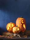 <p>This family of birds is a literal hoot. Carve out their cute expressions using <a href="https://www.womansday.com/home/crafts-projects/g950/funny-pumpkin-carving-ideas/?slide=32" rel="nofollow noopener" target="_blank" data-ylk="slk:free templates;elm:context_link;itc:0;sec:content-canvas" class="link ">free templates</a>, and then attach hand-painted nuts for tiny ears and feet. </p>