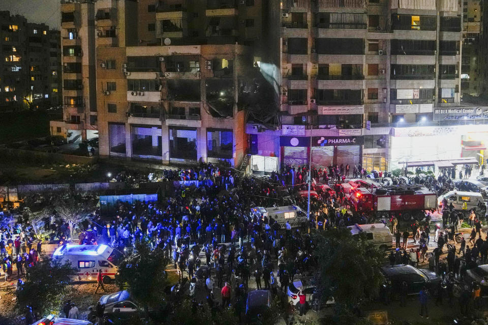 People search for survivors following a massive explosion in the southern suburb of Beirut, Lebanon, Tuesday, Jan. 2, 2024. (AP Photo/Hassan Ammar)