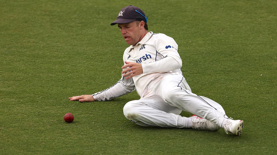 Marcus Harris slides to field a ball.