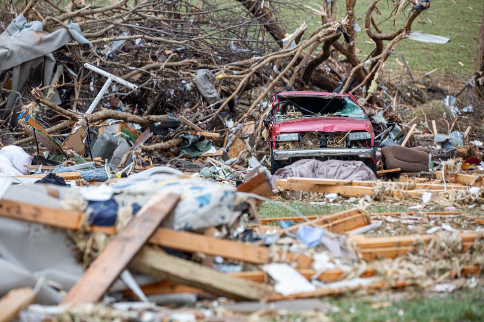 A car is badly damaged at the home of Amanda Dye in Campbellsville, Kentucky after the area was hit by overnight tornadoes. Dec. 11, 2021