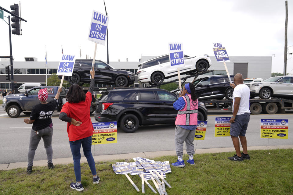 United Auto Workers picket outside the Chicago Ford Assembly Plant as Ford vehicles are transported Friday, Sept. 29, 2023, in Chicago. (AP Photo/Charles Rex Arbogast)