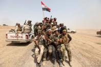 Iraq's Shi'ite paramilitaries ride in military vehicles in Nibai May 26, 2015. REUTERS/Stringer