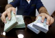 FILE PHOTO: A money exchange vendor displays Lebanese pound banknotes at his shop in Beirut