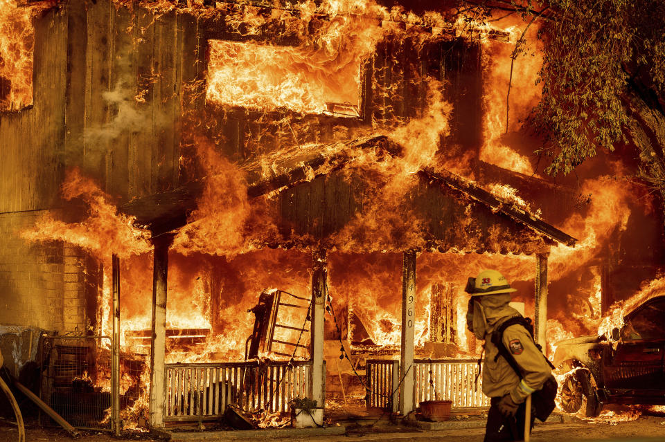 Fire consumes a home as the Sugar Fire, part of the Beckwourth Complex Fire, tears through Doyle, Calif., on Saturday, July 10, 2021. Pushed by heavy winds, the fire came out of the hills and destroyed multiple residences in central Doyle. (AP Photo/Noah Berger)