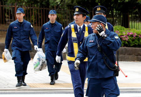 Policemen walk near the Imperial Palace in Tokyo, Japan, April 29, 2019. REUTERS/Kim Kyung-hoon