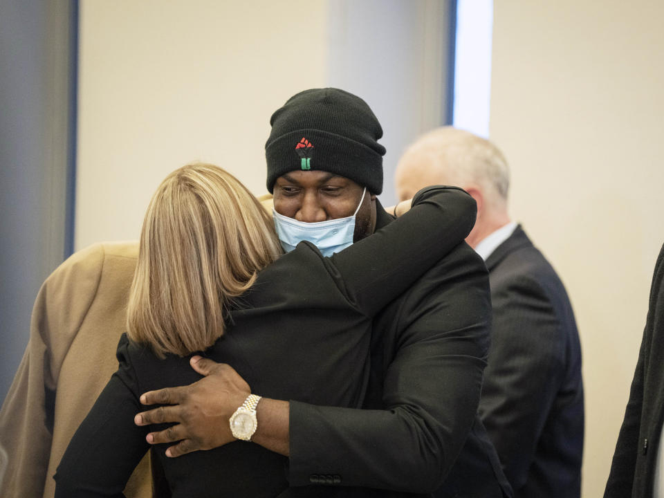 George Floyd's brother Philonise Floyd hugs members of the U.S. attorney's prosecution team after former Minneapolis police officers J. Alexander Kueng, Thomas Lane and Tou Thao were found guilty of violating George Floyd's civil rights at the Federal Courthouse on Thursday, Feb. 24, 2022 in St. Paul, Minn. (Renée Jones Schneider/Star Tribune via AP)