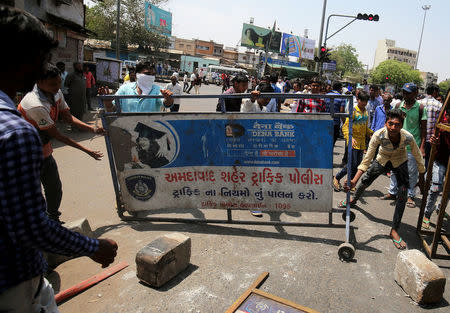 People belonging to the Dalit community move a barricade to block the road during a nationwide strike called by Dalit organisations, in Ahmedabad, India, April 2, 2018. REUTERS/Amit Dave